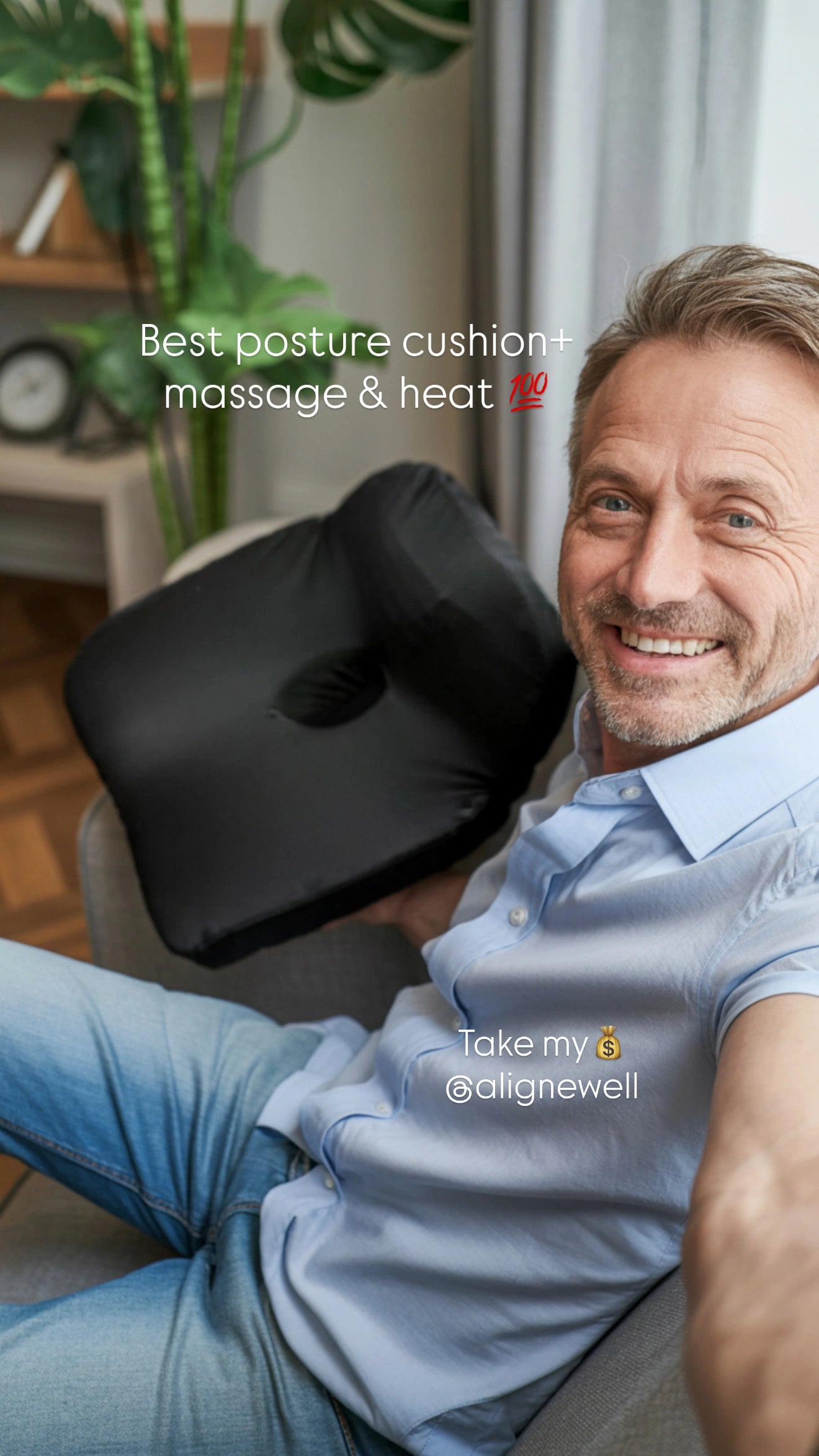 Man sitting with a black cushion on his lap, smiling, with text overlay about a posture cushion, massage, and heat feature.